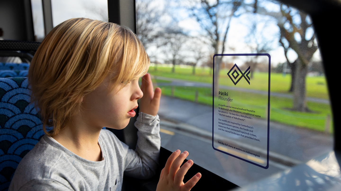 Kid looking out of window of Metro bus