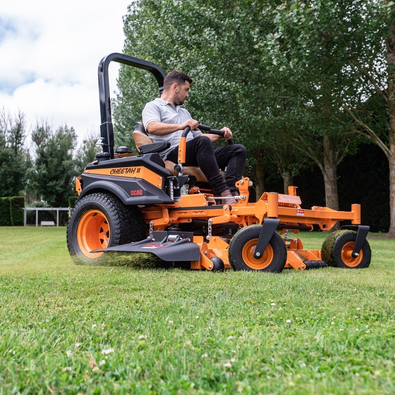 Person operating SCAG ride on mower