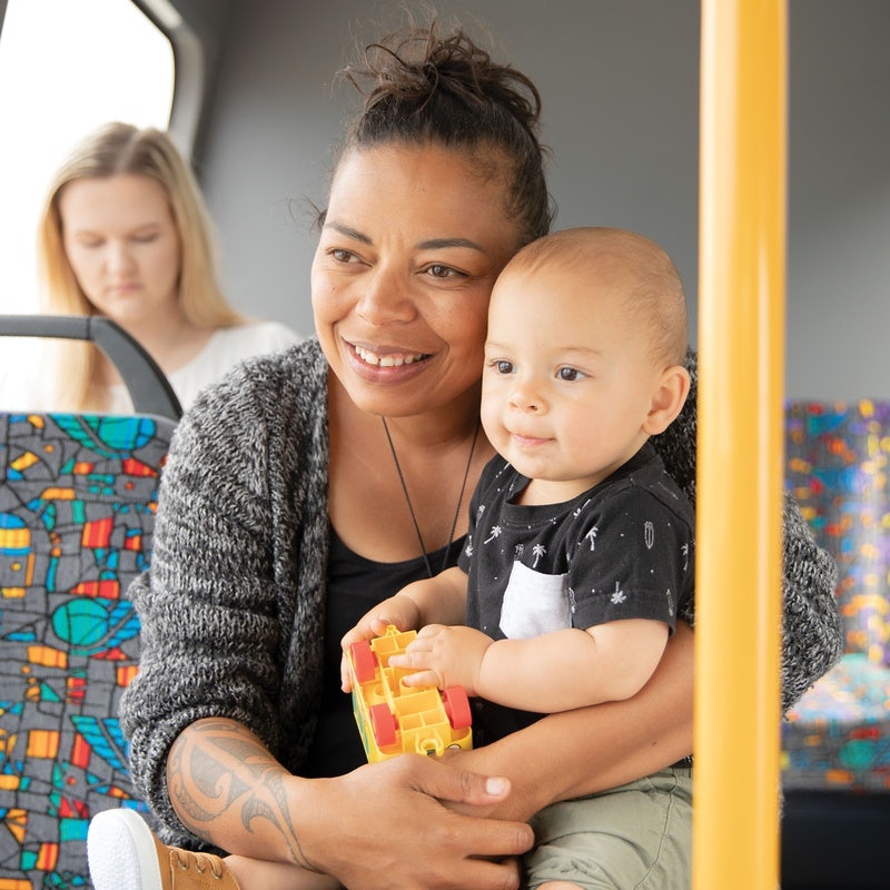 Mother with child holding toy on a bus