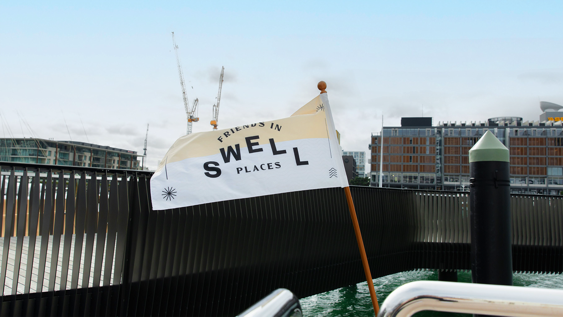 Concept of Sail GP Friends in Swell Places branded flag on a dock