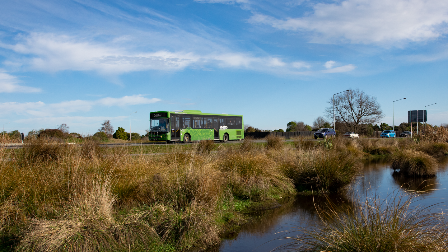 Metro bus driving past swamplands