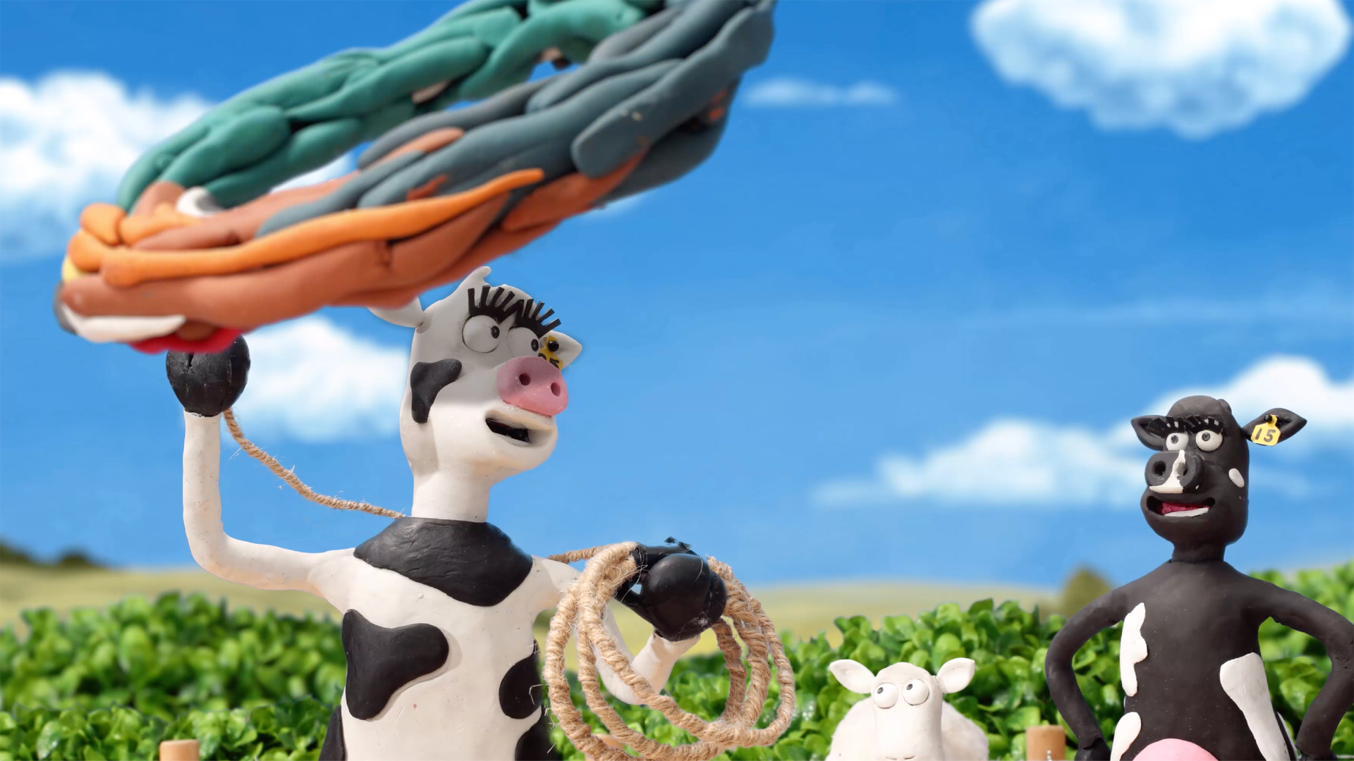 RAGT NZ cow with lasso as sheep and cow characters look on