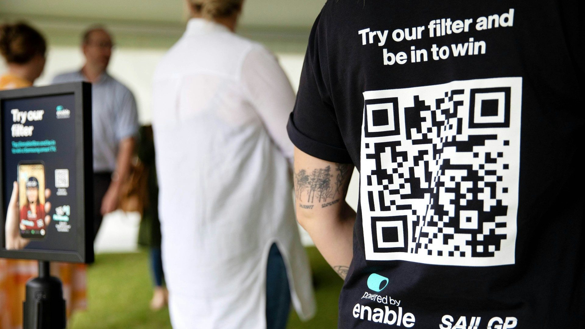 Closeup of person wearing t-shirt with QR code for Enable filter