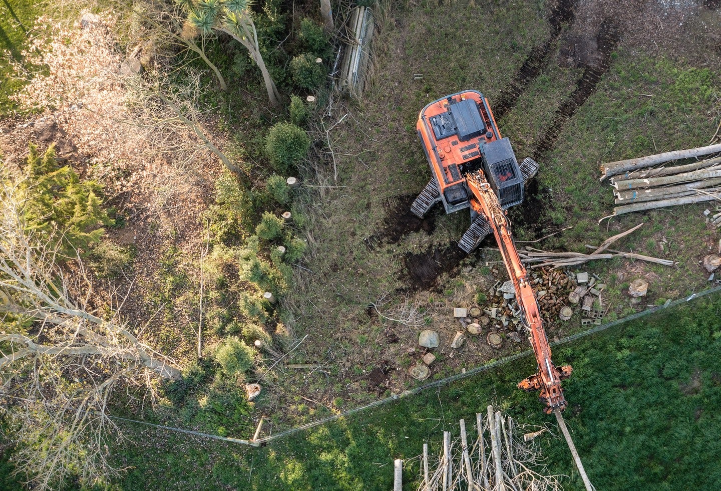 Drone visual of a excavator removing trees from a paddock