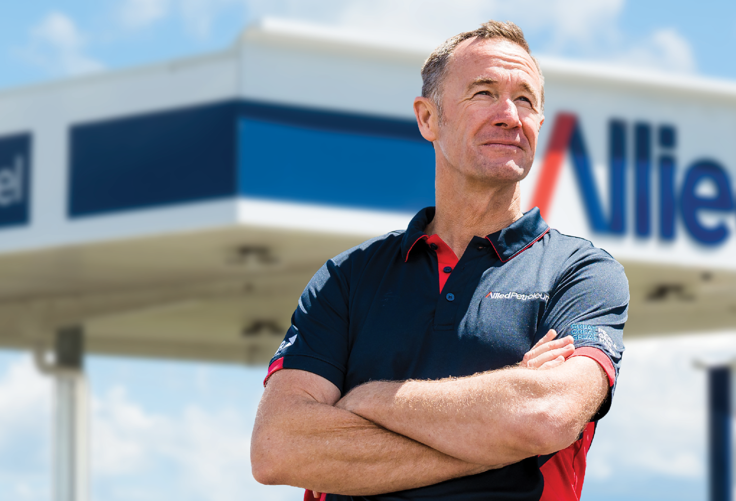 Greg Murphy standing in front of Allied Petroleum fuel station
